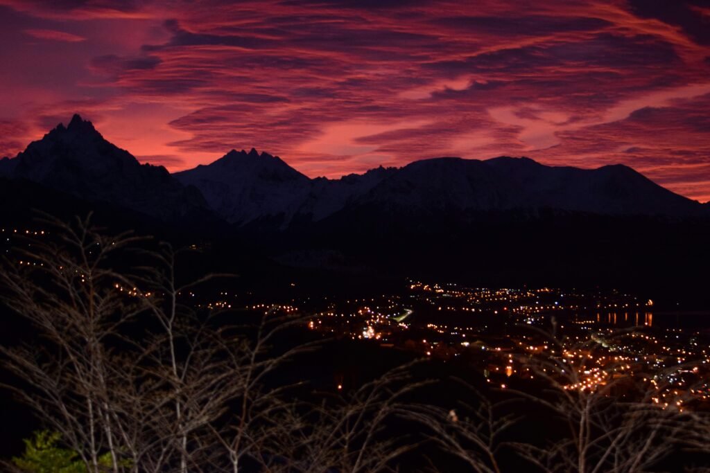Captivating twilight view of Ushuaia's city lights under a vivid purple sky.