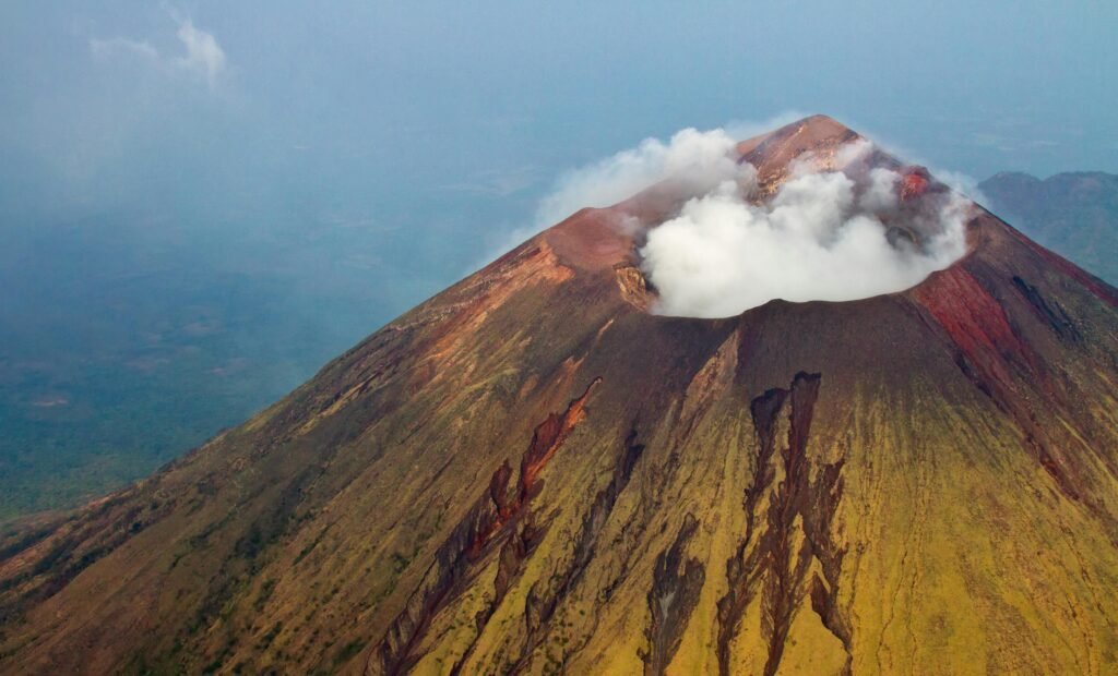 Stunning aerial view of San Cristobal Volcano in Nicaragua with smoke and steam rising from the crater.